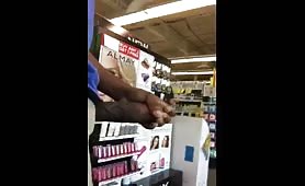 Dude jerking off his fat cock in store in front of a employee