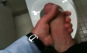 Stroking my thick cock in a public toilet