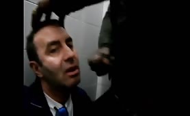 White guy sucks a black guy cock in a public toilet